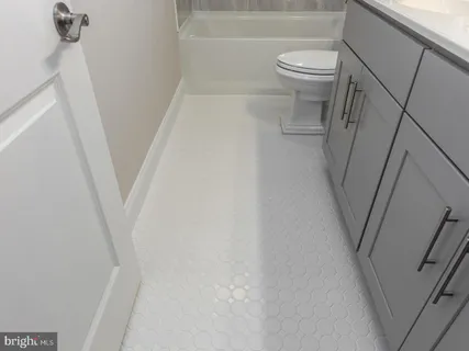 a kitchen with stainless steel appliances granite countertop a sink a stove a refrigerator and island