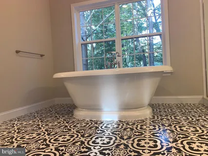 a kitchen with stainless steel appliances a stove a sink and a window