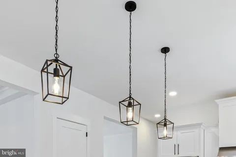 a view of staircase with wooden floor and white walls