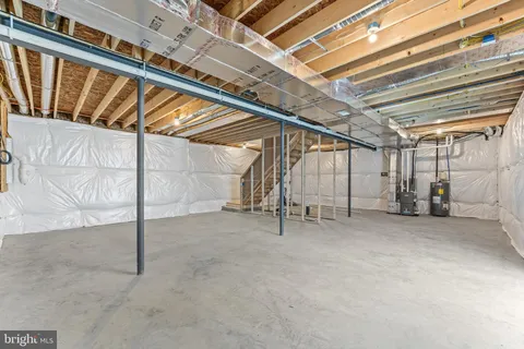 a view of staircase with wooden floor and white walls