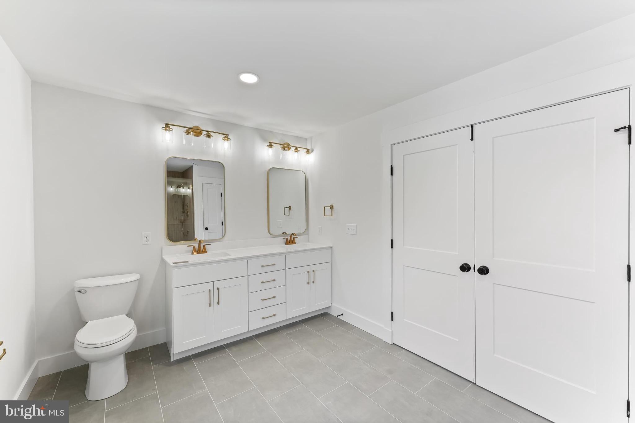 183 Ellicott Road Avondale, PA 19311 - Photo 52 of 92 a spacious bathroom with a granite countertop sink mirror and toilet