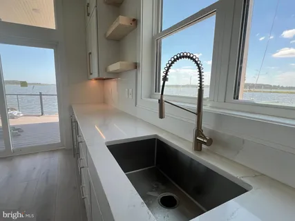 a kitchen with granite countertop a refrigerator a stove and a refrigerator