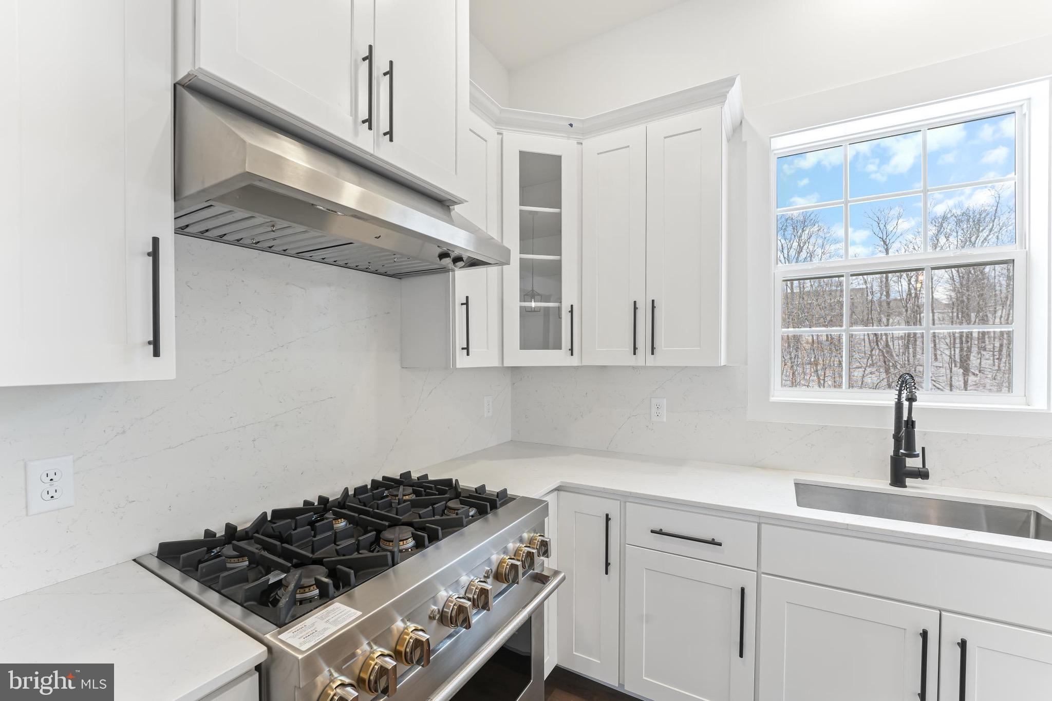 183 Ellicott Road Avondale, PA 19311 - Photo 74 of 92 a kitchen with stainless steel appliances a stove a sink and a window