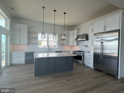 a stove top oven sitting inside of a kitchen