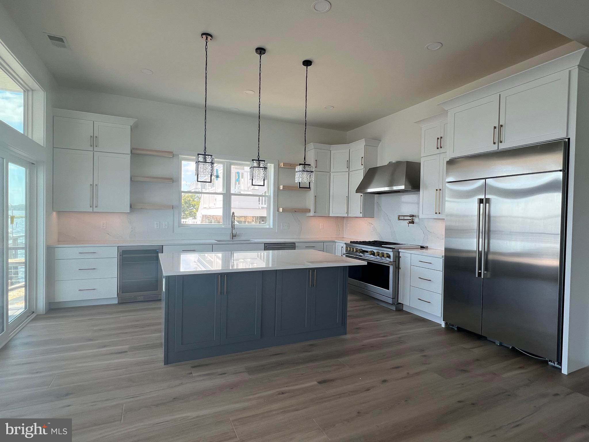 183 Ellicott Road Avondale, PA 19311 - Photo 8 of 92 a kitchen with stainless steel appliances granite countertop a sink a stove a refrigerator and island with wooden floor