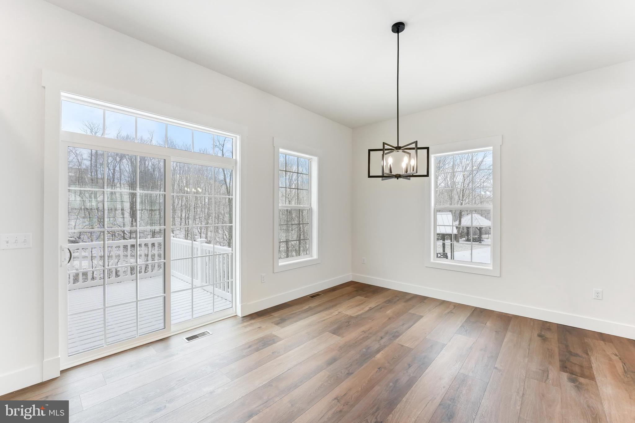 183 Ellicott Road Avondale, PA 19311 - Photo 81 of 92 a view of an empty room with wooden floor and a window