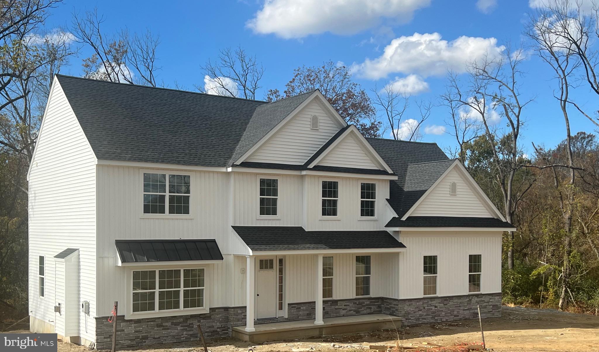 183 Ellicott Road Avondale, PA 19311 - Photo 92 of 92 a view of a white house with large windows and a yard