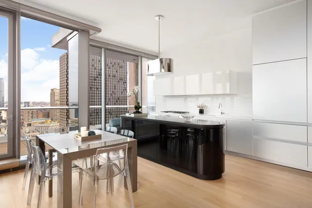 a kitchen with a sink stove and white cabinets