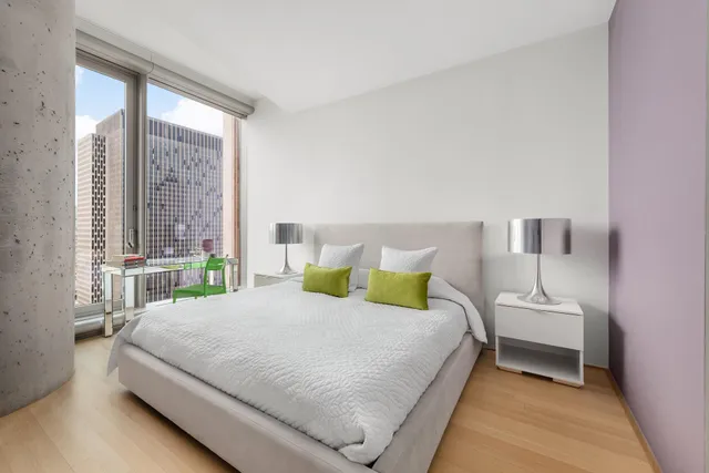 a bedroom with a bed and window