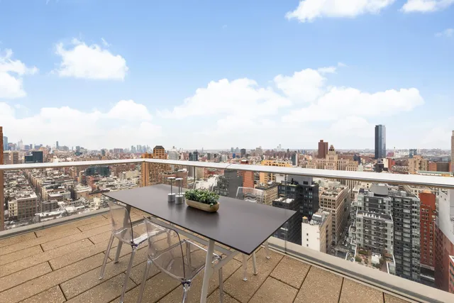 a terrace with outdoor seating and city view