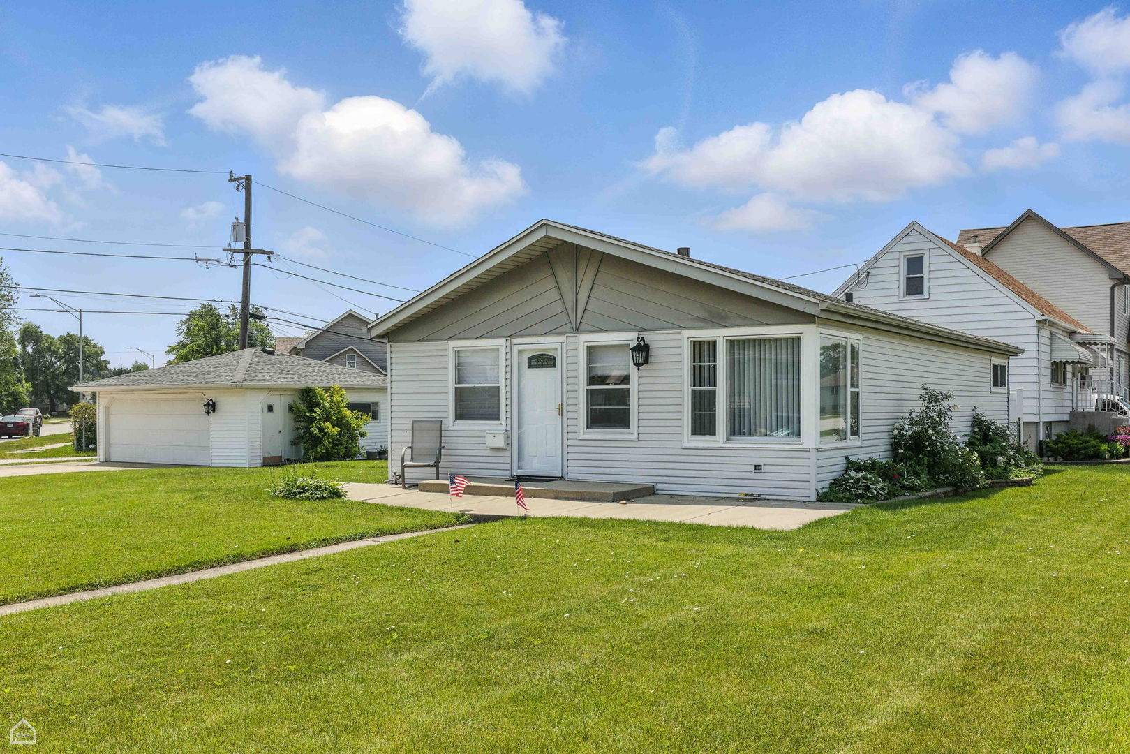 5301 State Road Burbank, IL 60459 - Photo 1 of 18 a big house with a big yard and potted plants in front of it