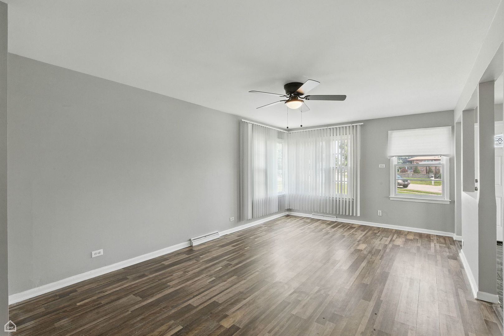 5301 State Road Burbank, IL 60459 - Photo 4 of 18 a view of an empty room with a window and wooden floor