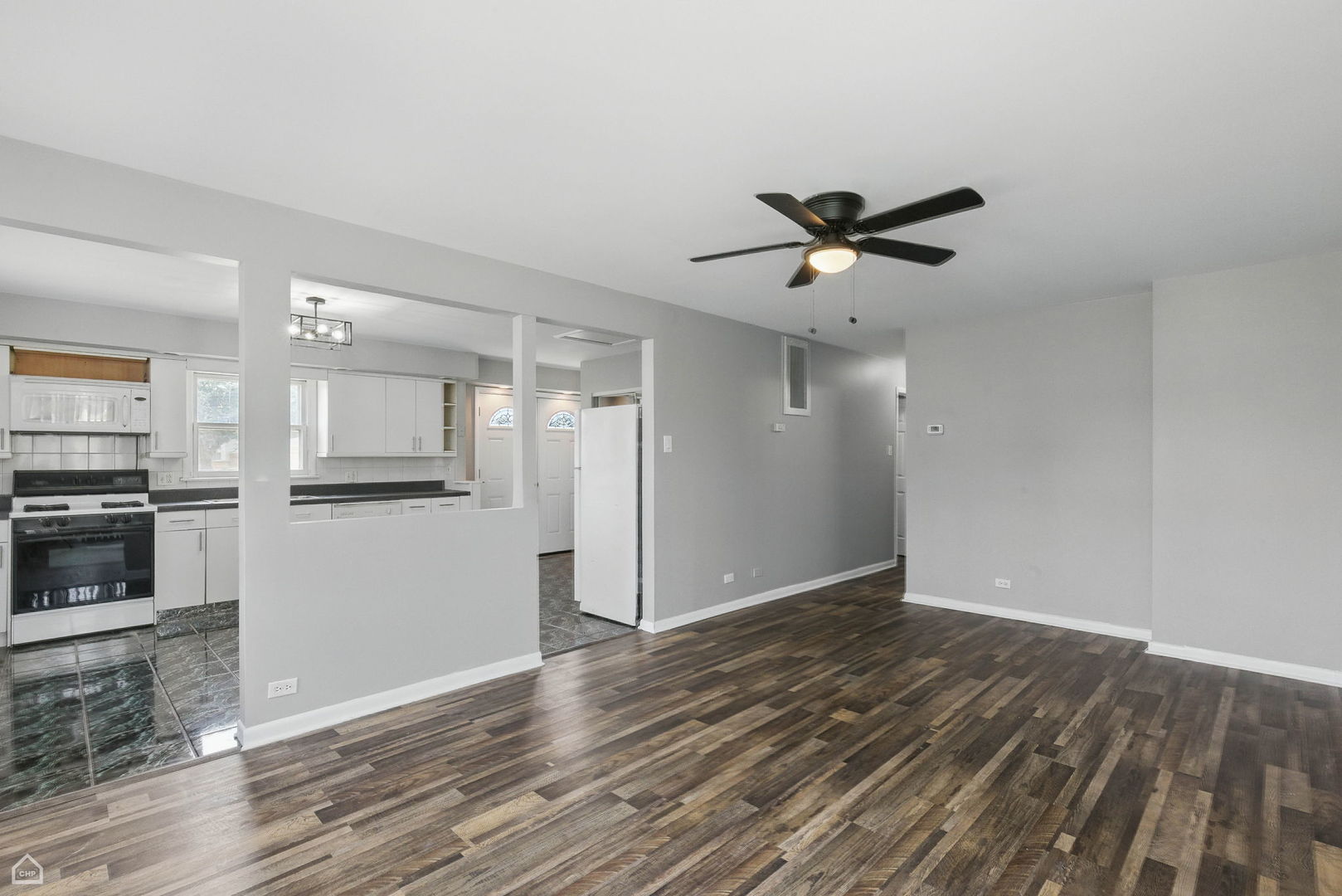 5301 State Road Burbank, IL 60459 - Photo 5 of 18 a view of a kitchen with wooden floor and a refrigerator