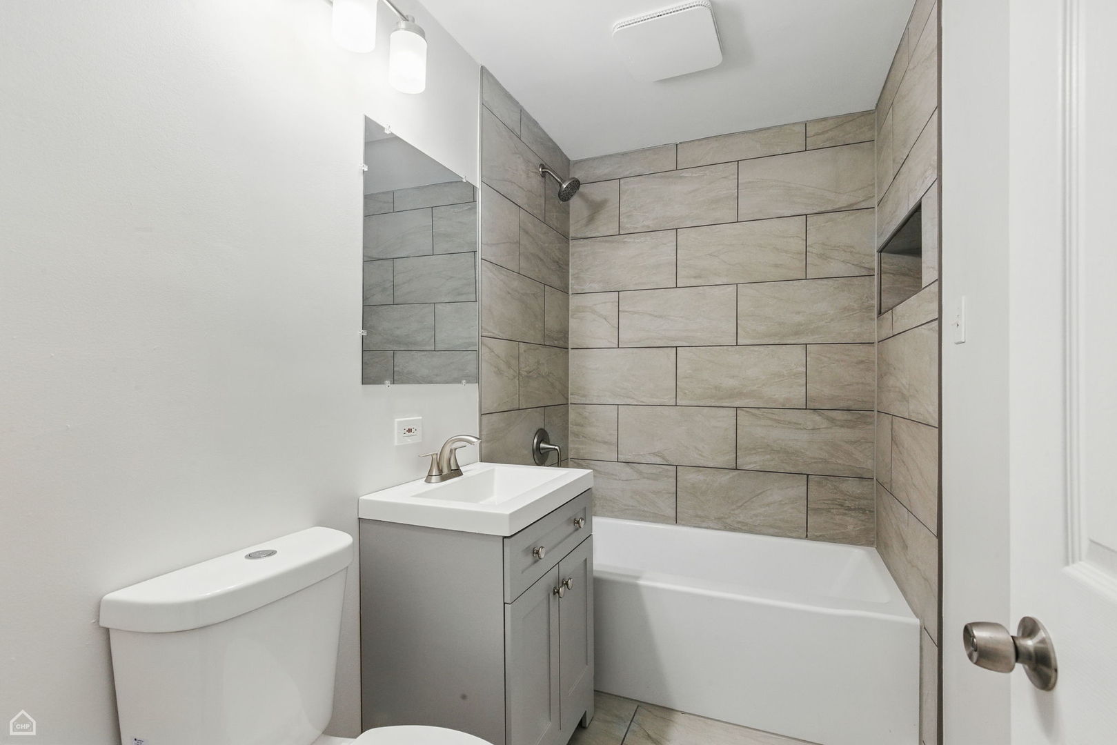 5301 State Road Burbank, IL 60459 - Photo 8 of 18 a bathroom with a sink a toilet and shower