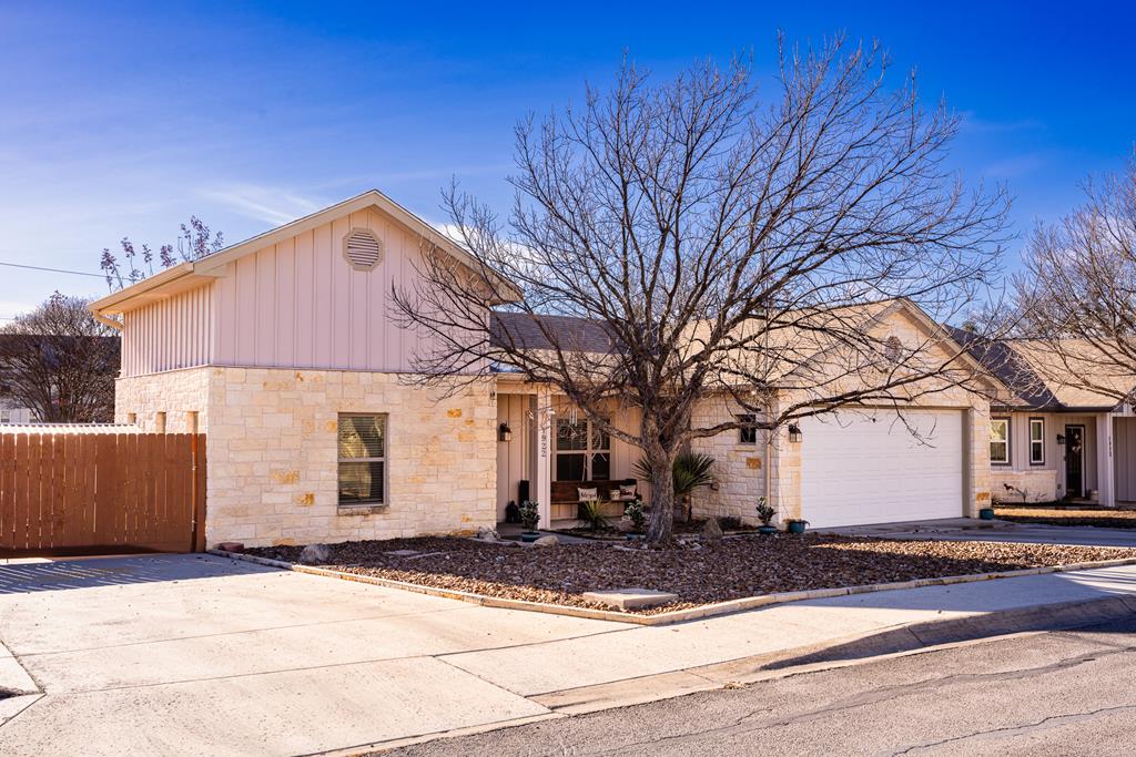 1922 Weston Loop Kerrville, TX 78028 - Photo 1 of 22 a front view of a house with a yard and garage
