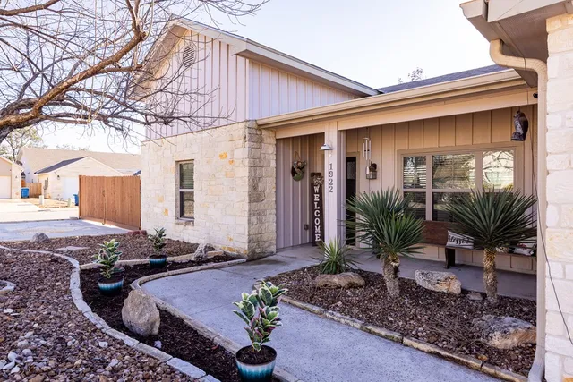 a front view of house with yard outdoor seating and barbeque oven
