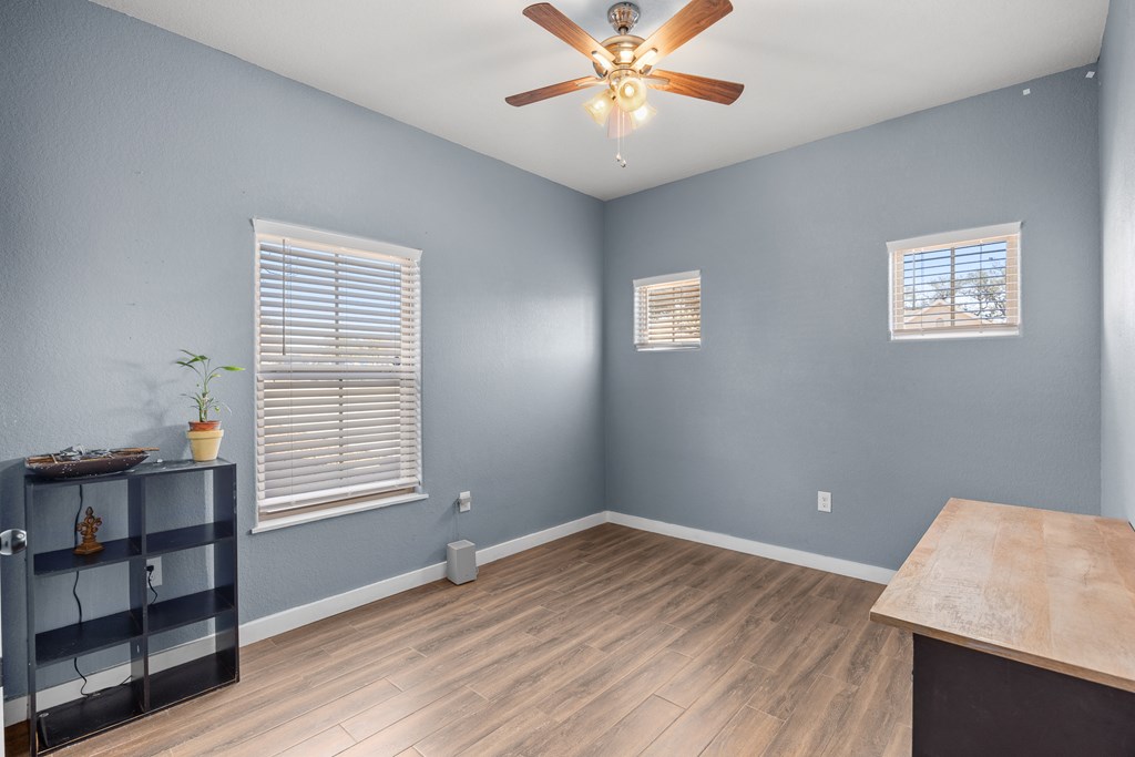 1922 Weston Loop Kerrville, TX 78028 - Photo 13 of 22 a view of an empty room with a window and wooden floor