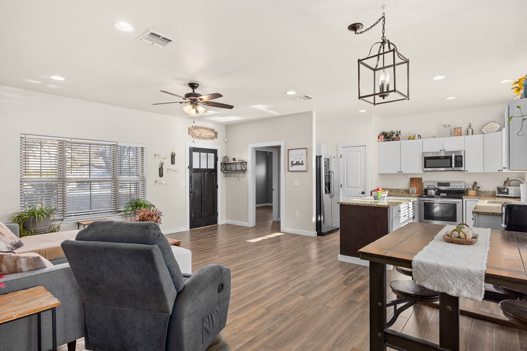 1922 Weston Loop Kerrville, TX 78028 - Photo 2 of 22 a living room with stainless steel appliances kitchen island granite countertop furniture and a kitchen view