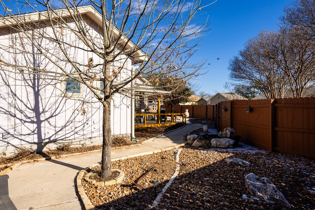1922 Weston Loop Kerrville, TX 78028 - Photo 22 of 22 a front view of a house with yard covered in snow