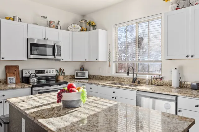 a kitchen with a stove a sink and a microwave