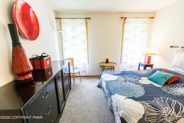 a bedroom with bed and a window