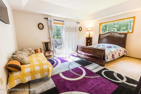 a bedroom with two beds and a window