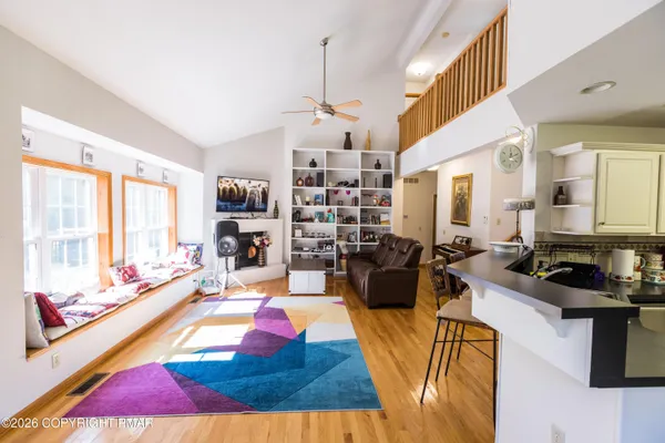 a living room with furniture fireplace and flat screen tv