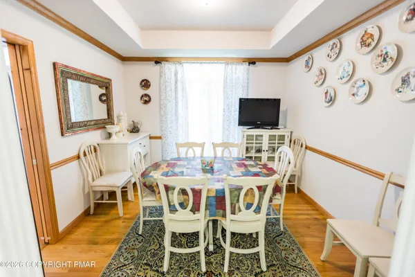 a dining room with furniture and wooden floor