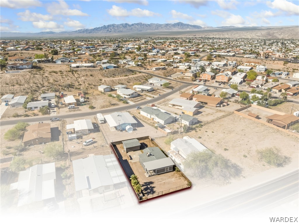1628 Ramar Road Bullhead City, AZ 86442 - Photo 12 of 64 Aerial view of the property and its surrounding neighborhood, showcasing mountain views in the distance