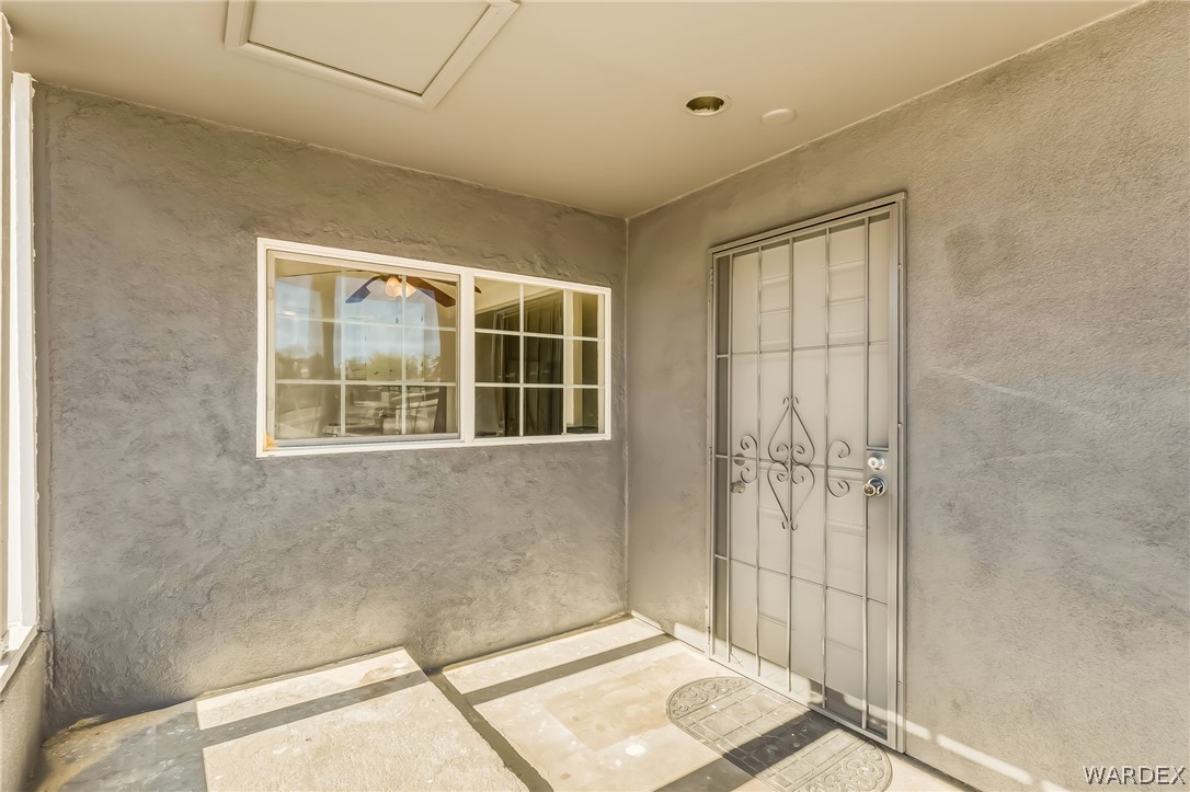 1628 Ramar Road Bullhead City, AZ 86442 - Photo 33 of 64 Front door with security gate and covered patio.