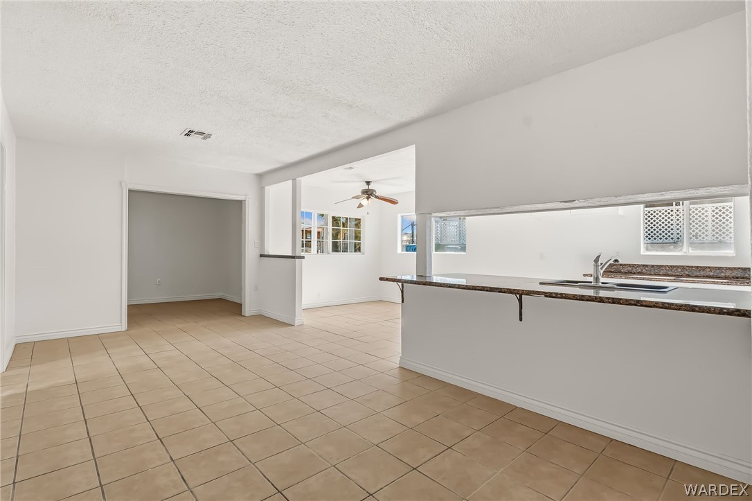 1628 Ramar Road Bullhead City, AZ 86442 - Photo 43 of 64 The property features a kitchen area with a sink, countertop, and a breakfast bar