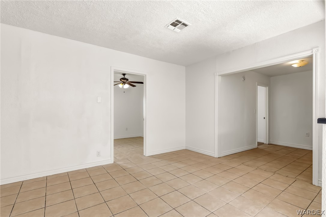 1628 Ramar Road Bullhead City, AZ 86442 - Photo 45 of 64 Living area features light-colored tile flooring and white walls, offering a bright and neutral palette