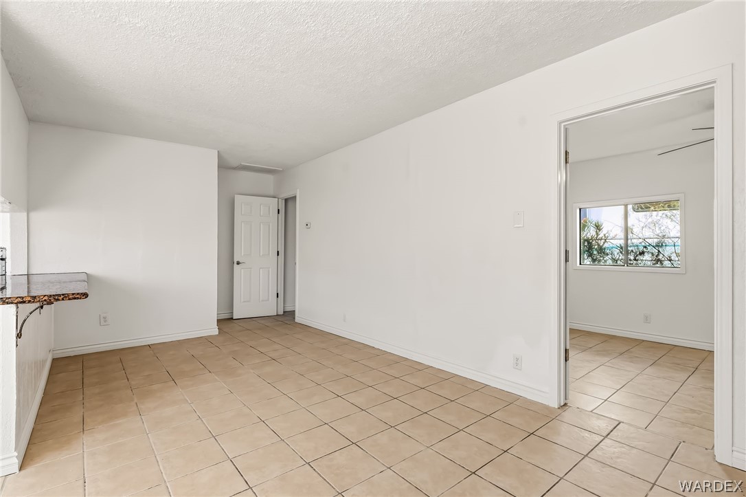1628 Ramar Road Bullhead City, AZ 86442 - Photo 46 of 64 This bright room features tile flooring and white walls, with a breakfast bar featuring a granite counter