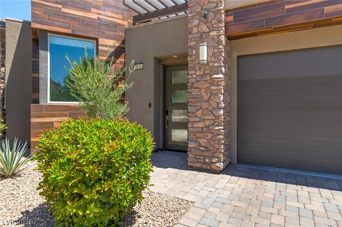 6014 Willow Ridge Court Las Vegas, NV 89135 - Photo 5 of 99 This contemporary home features an inviting entrance with paver walkways and lush landscaping.