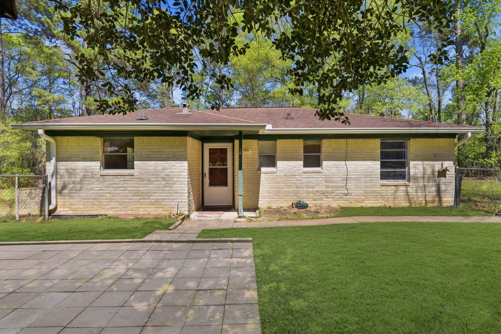 7555 Fm 1725 Road Coldspring, TX 77331 - Photo 1 of 31 a front view of a house with a yard and garage