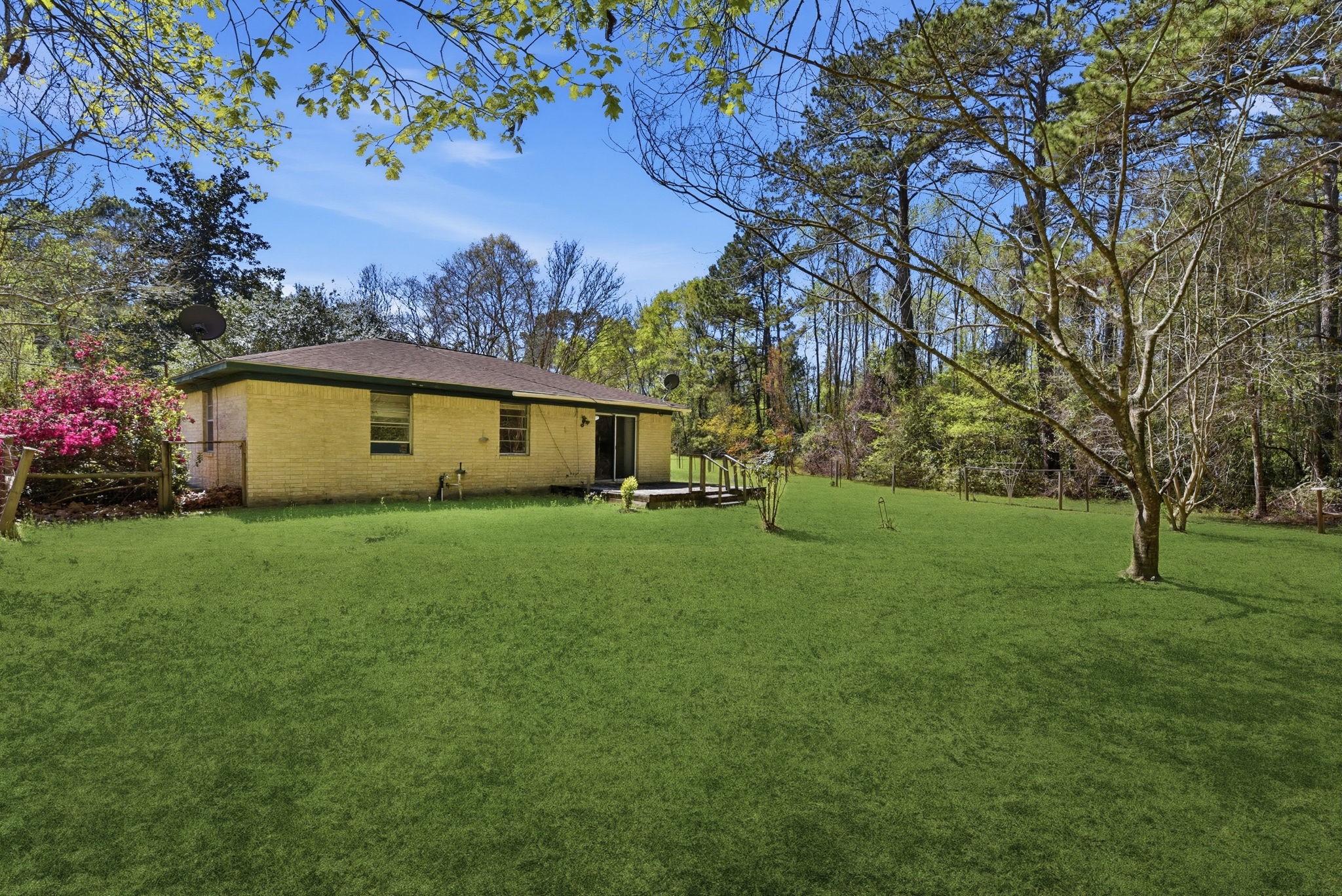 7555 Fm 1725 Road Coldspring, TX 77331 - Photo 19 of 31 a front view of a house with garden