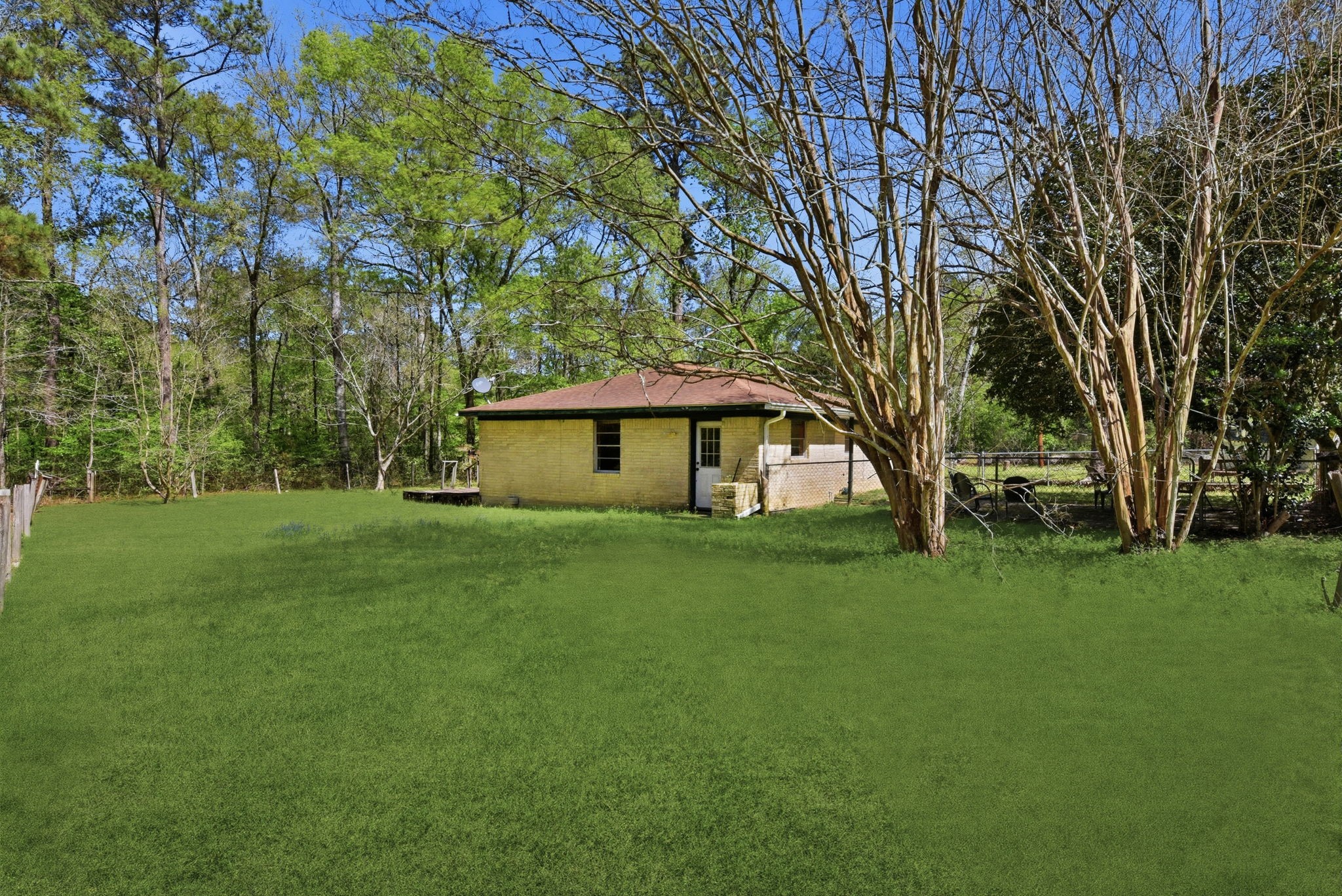 7555 Fm 1725 Road Coldspring, TX 77331 - Photo 21 of 31 a front view of a house with garden