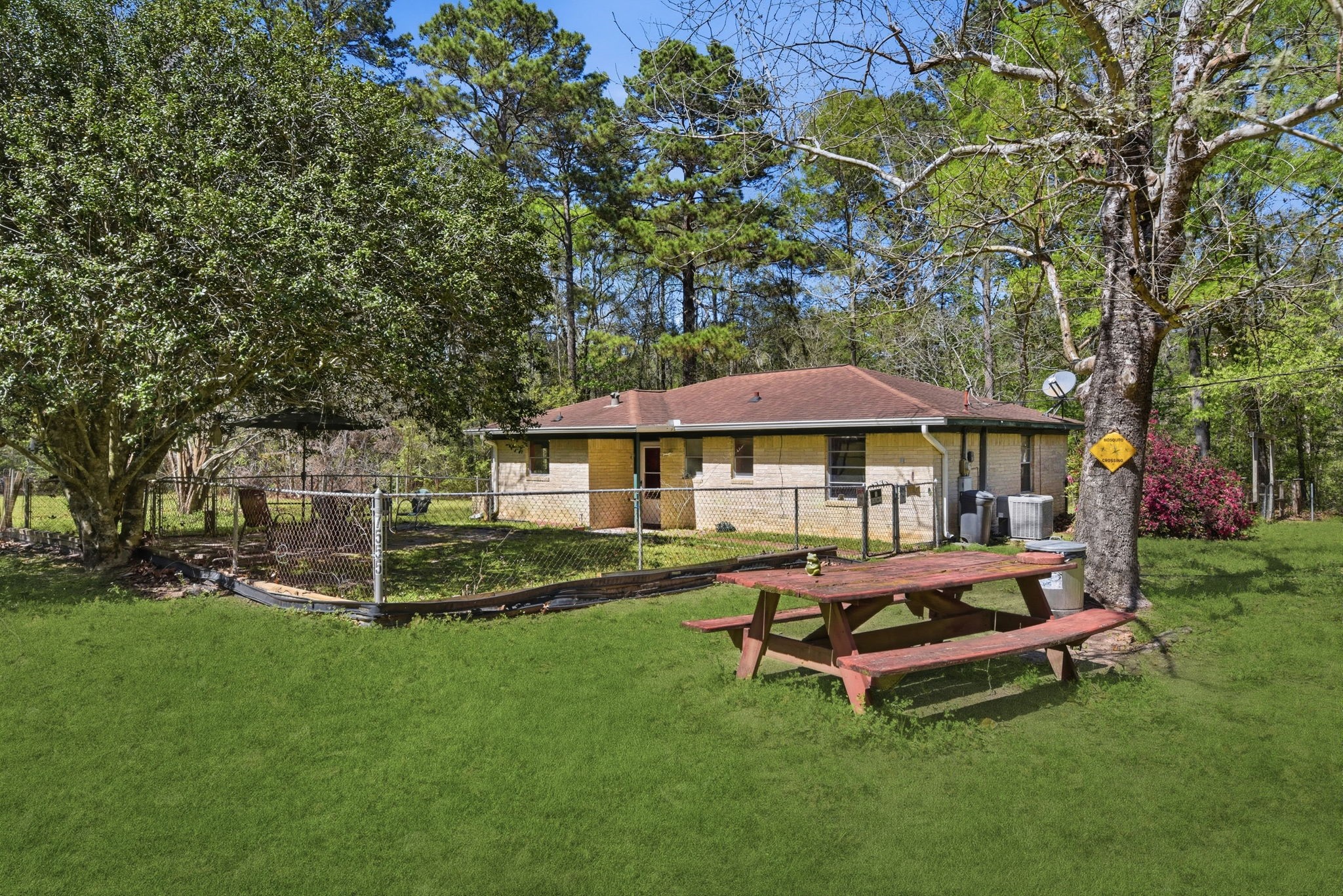 7555 Fm 1725 Road Coldspring, TX 77331 - Photo 22 of 31 a backyard of a house with table and chairs