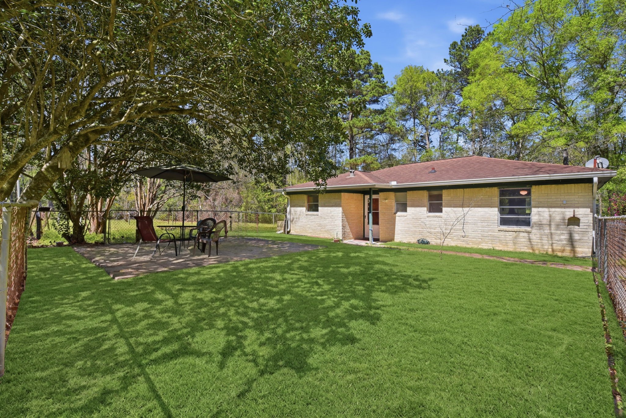 7555 Fm 1725 Road Coldspring, TX 77331 - Photo 3 of 31 a view of a house with backyard sitting area and garden