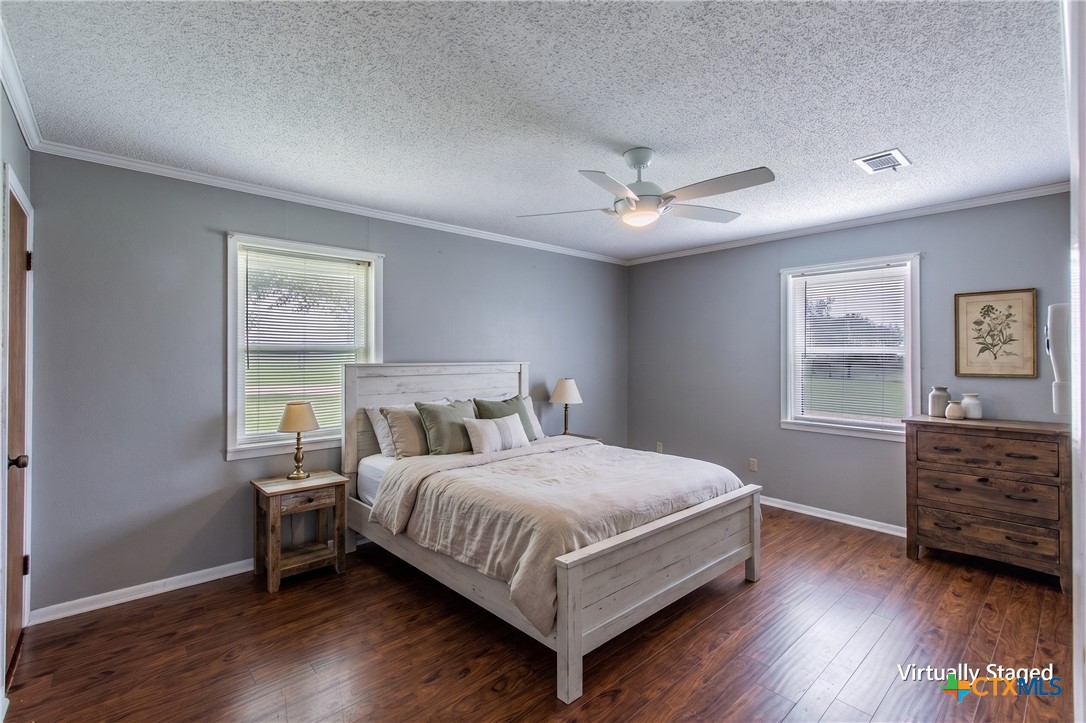 3053 Hobby Creek Road Burlington, TX 76519 - Photo 18 of 40 a bedroom with a bed chandelier and a window