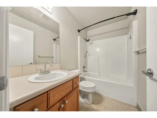 a bathroom with a sink toilet a mirror and shower
