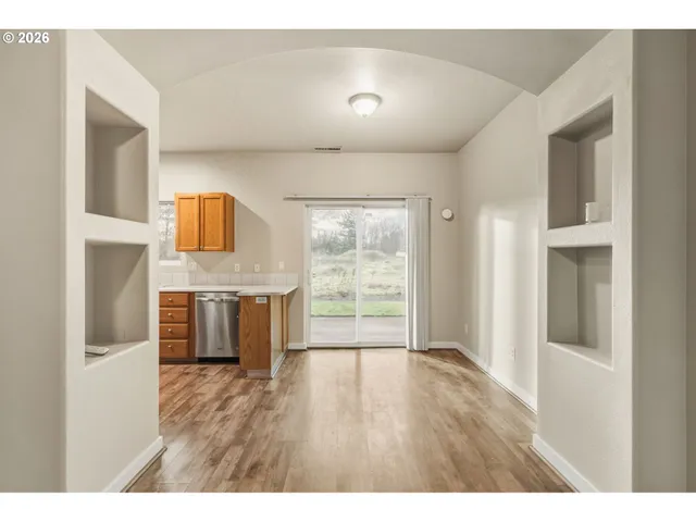 a open kitchen with cabinets and wooden floor