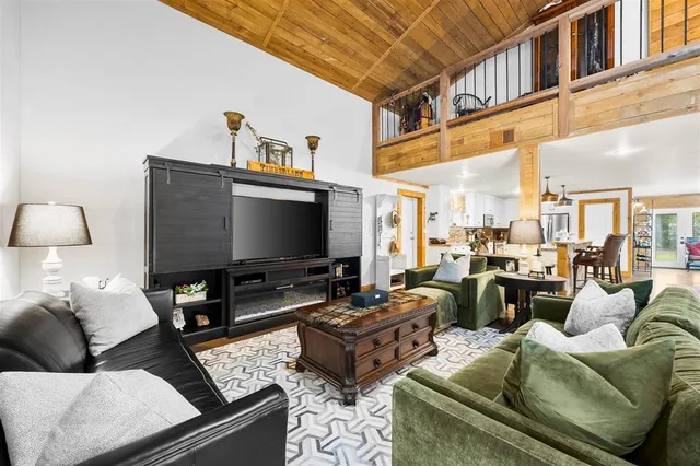 a living room with furniture ceiling fan and a rug