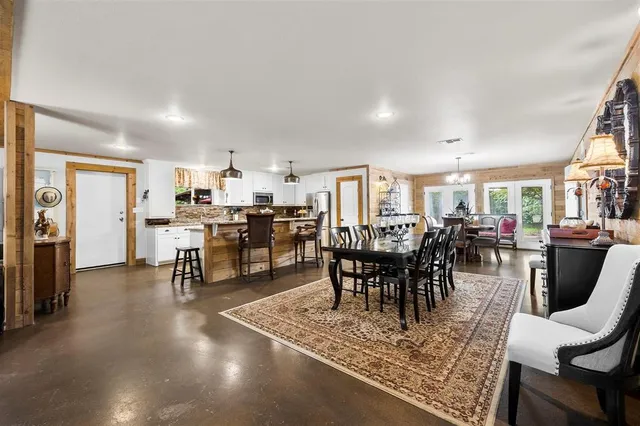 a room with table chairs and a wooden floor