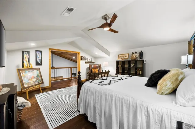 a bedroom with furniture and a flat screen tv