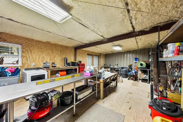 a view of a storage room with furniture bicycles and windows