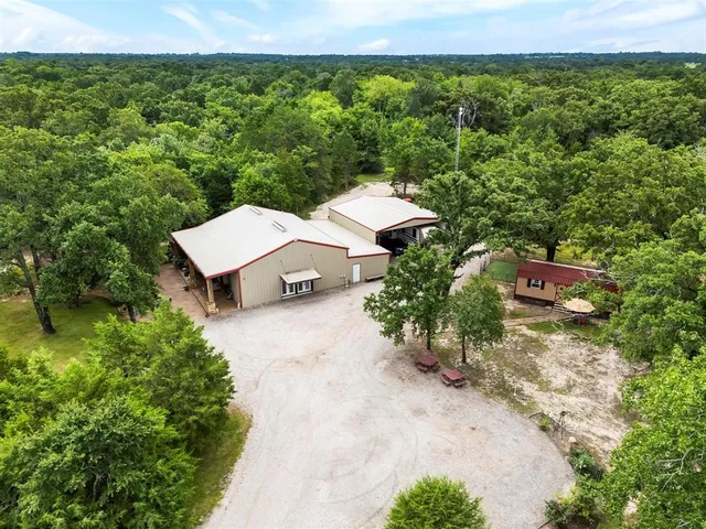 an aerial view of a house with yard and outdoor seating