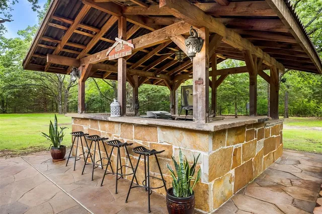 a view of swimming pool with outdoor seating and plants
