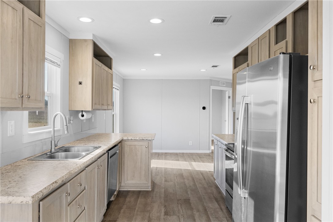5236 County Road 219 Anderson, TX 77830 - Photo 11 of 35 a kitchen with a sink and refrigerator
