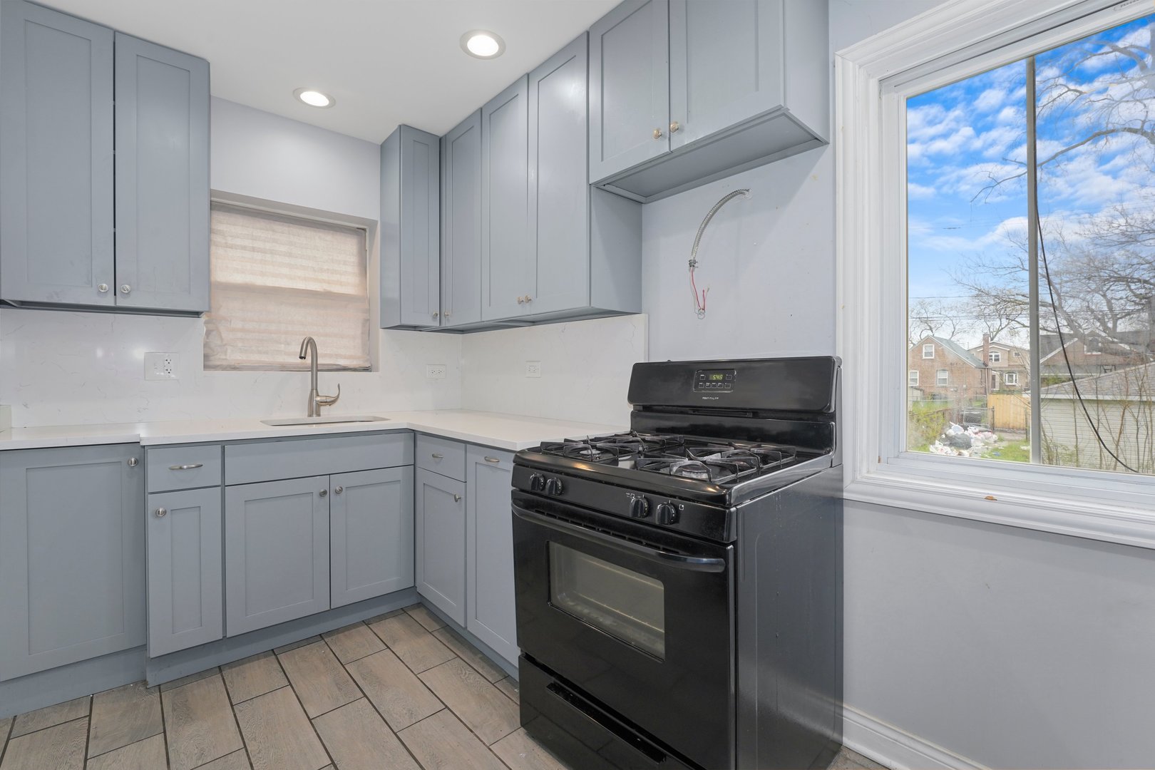 10233 South Calhoun Avenue Chicago, IL 60617 - Photo 11 of 22 a kitchen with a stove and a sink